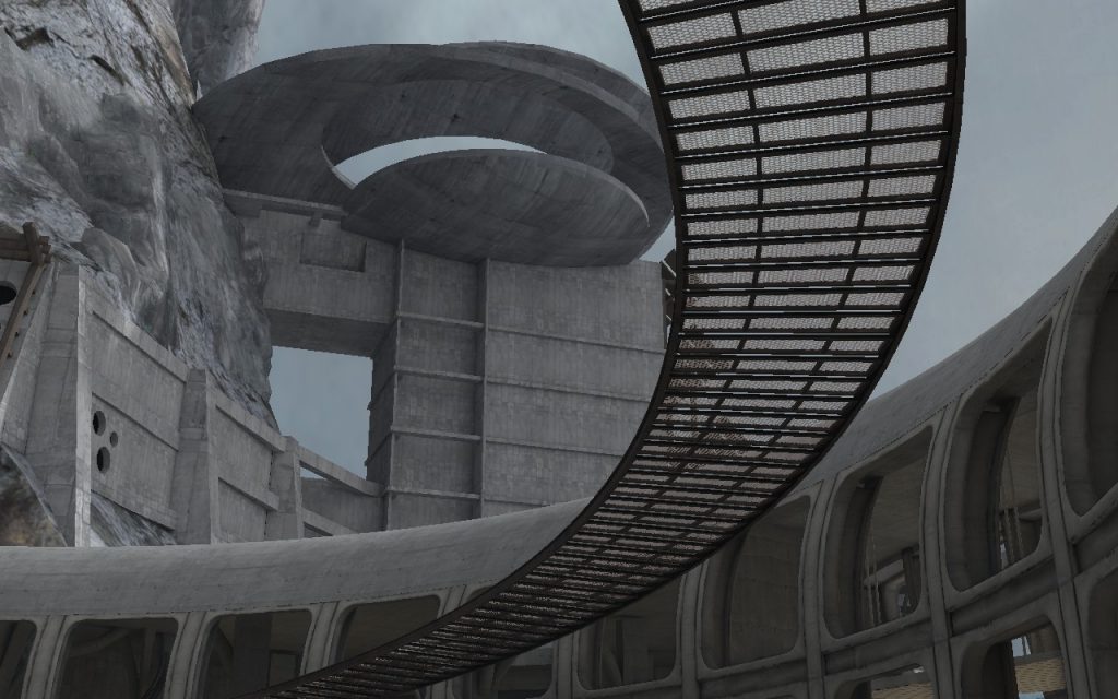 The exterior of a brutalist building with a curving walkway overhead and made of various geometric shapes.