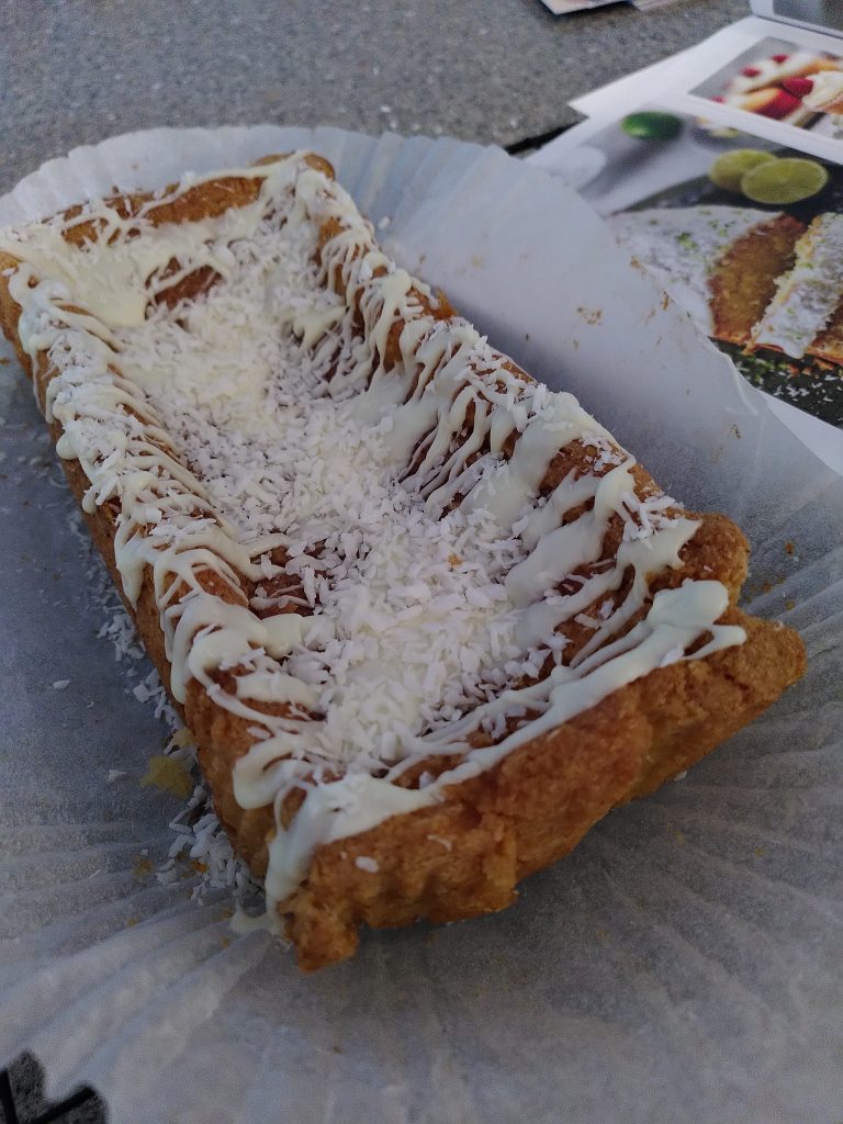 A dodgy, sunken looking cake with icing drizzled over it fairly badly if I'm honest.