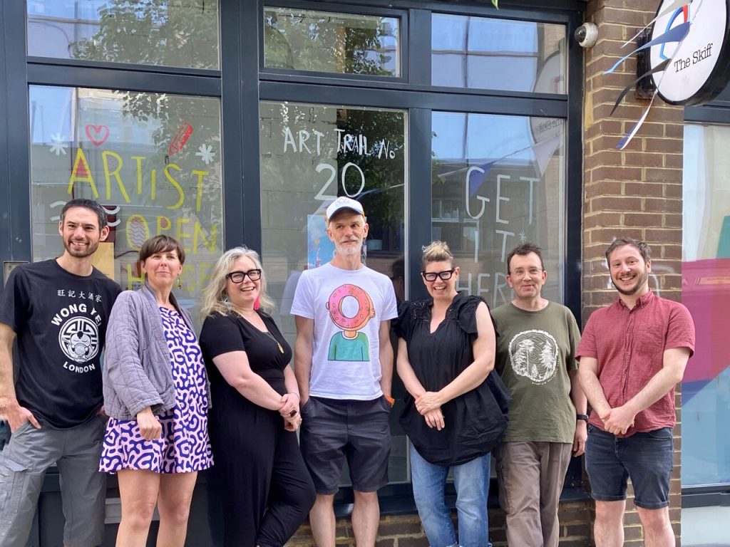 Photo of a bunch of 7 lovely people (1 missing) outside the entrance to the Skiff in Brighton.